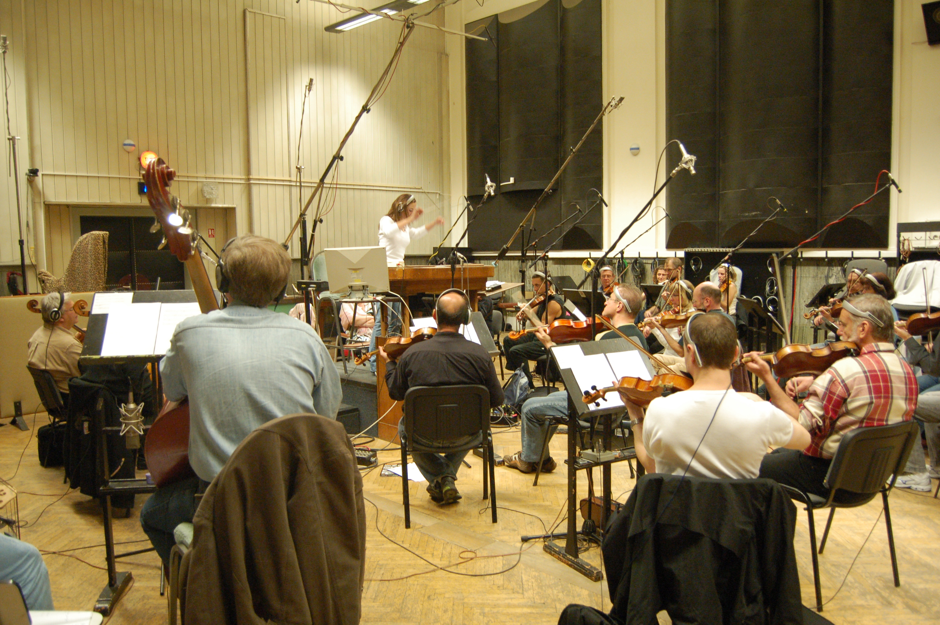 Rachel James conducting one of her scores with the City of Prague Philharmonic orchestra.