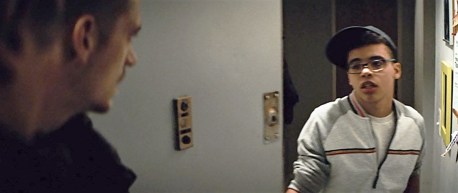 Devon O'Brien greets Liam Neeson and Joel Kinnaman at the door in Run All Night
