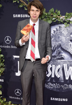Matty Cardarople enjoying a slice of pizza at the Jurassic World premiere.