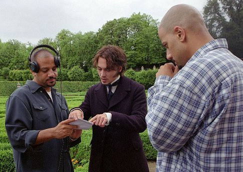 Directors Allen Hughes (left) and Albert Hughes (right) discuss a scene with Johnny Depp on a location in the Czech Republic.