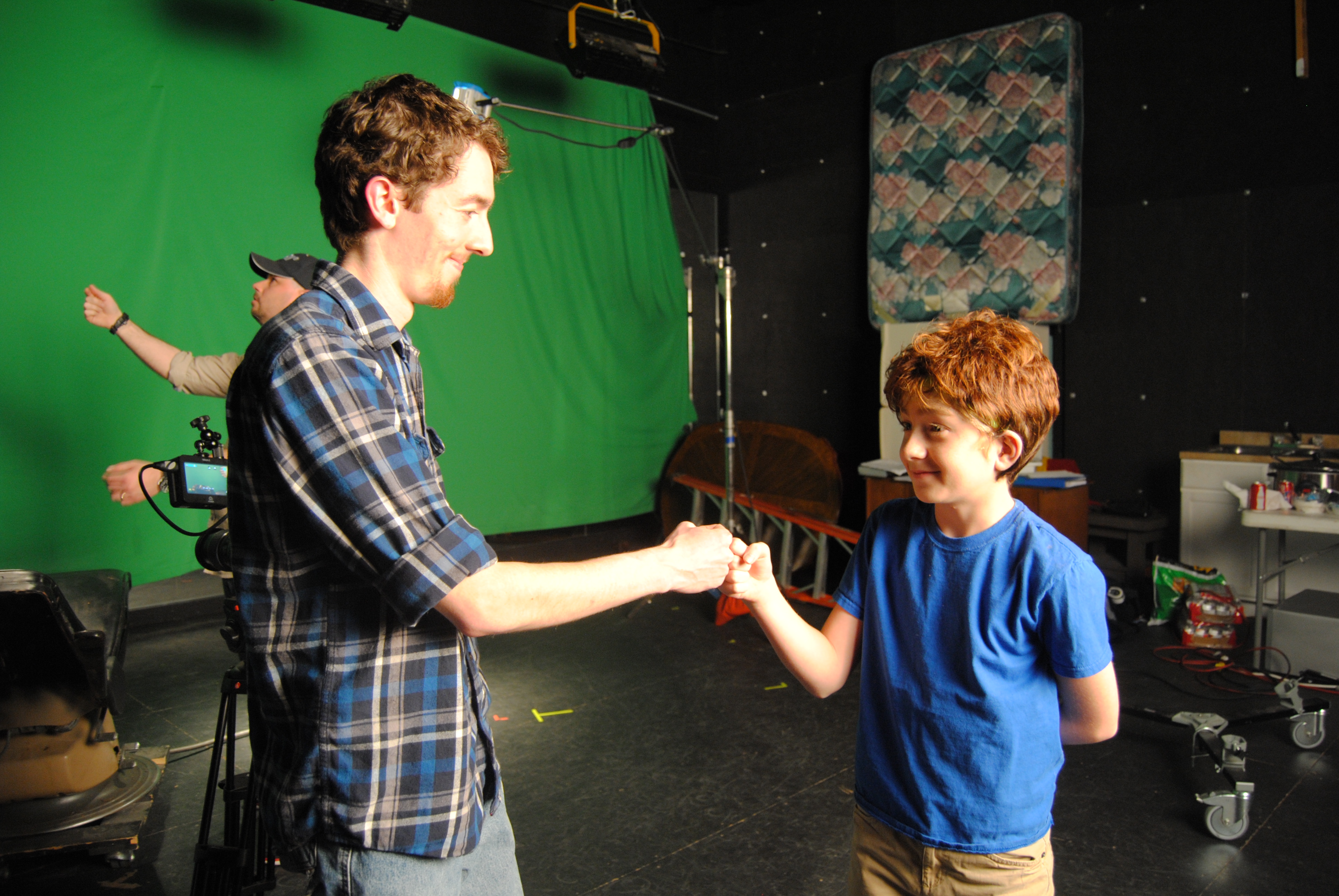 Director Blake Cortright [L] share a moment on set with actor Bailey Harkins [R] between takes of 