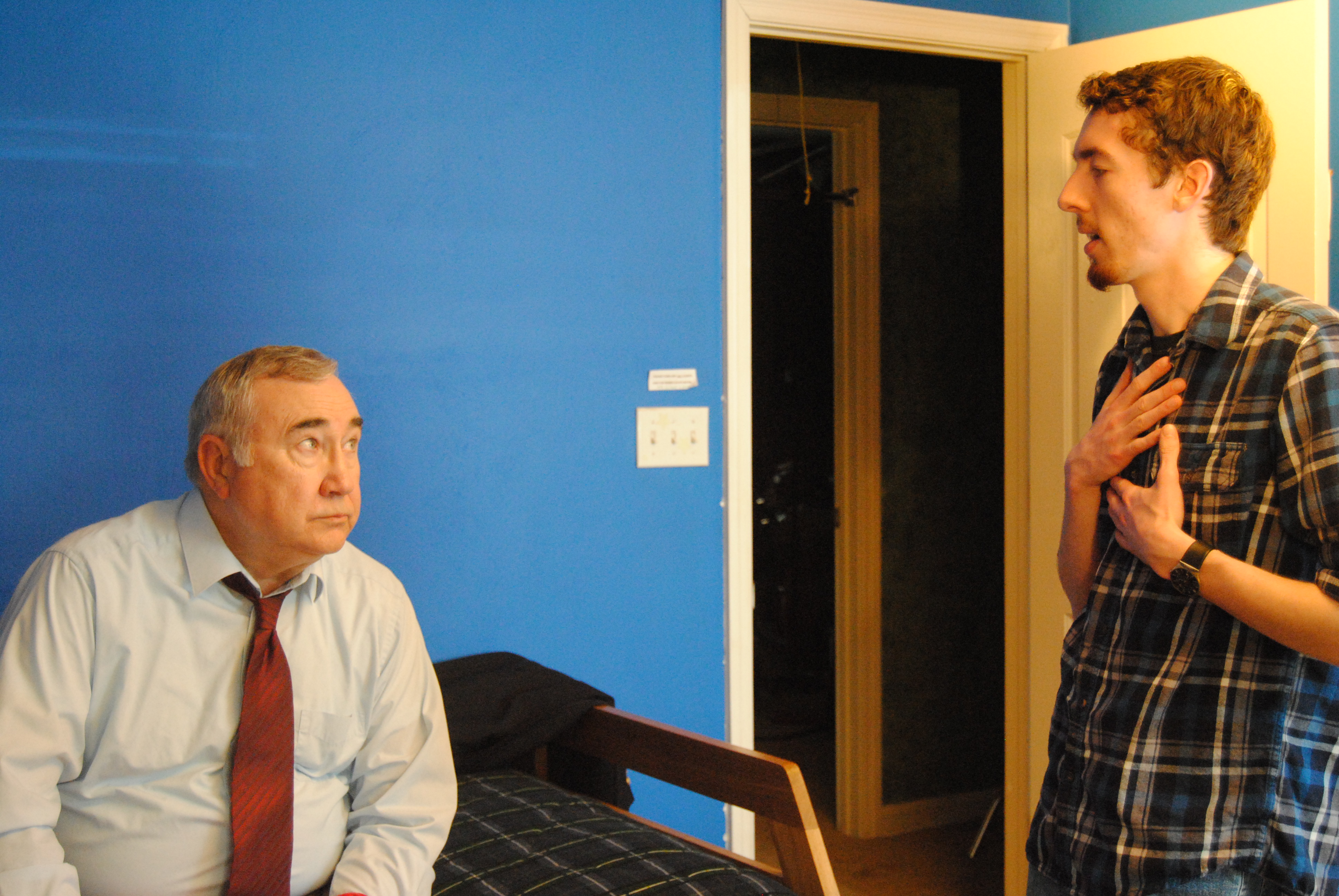 Director Blake Cortright [R] discusses a scene with actor Robert Shepherd [L] on the set of 