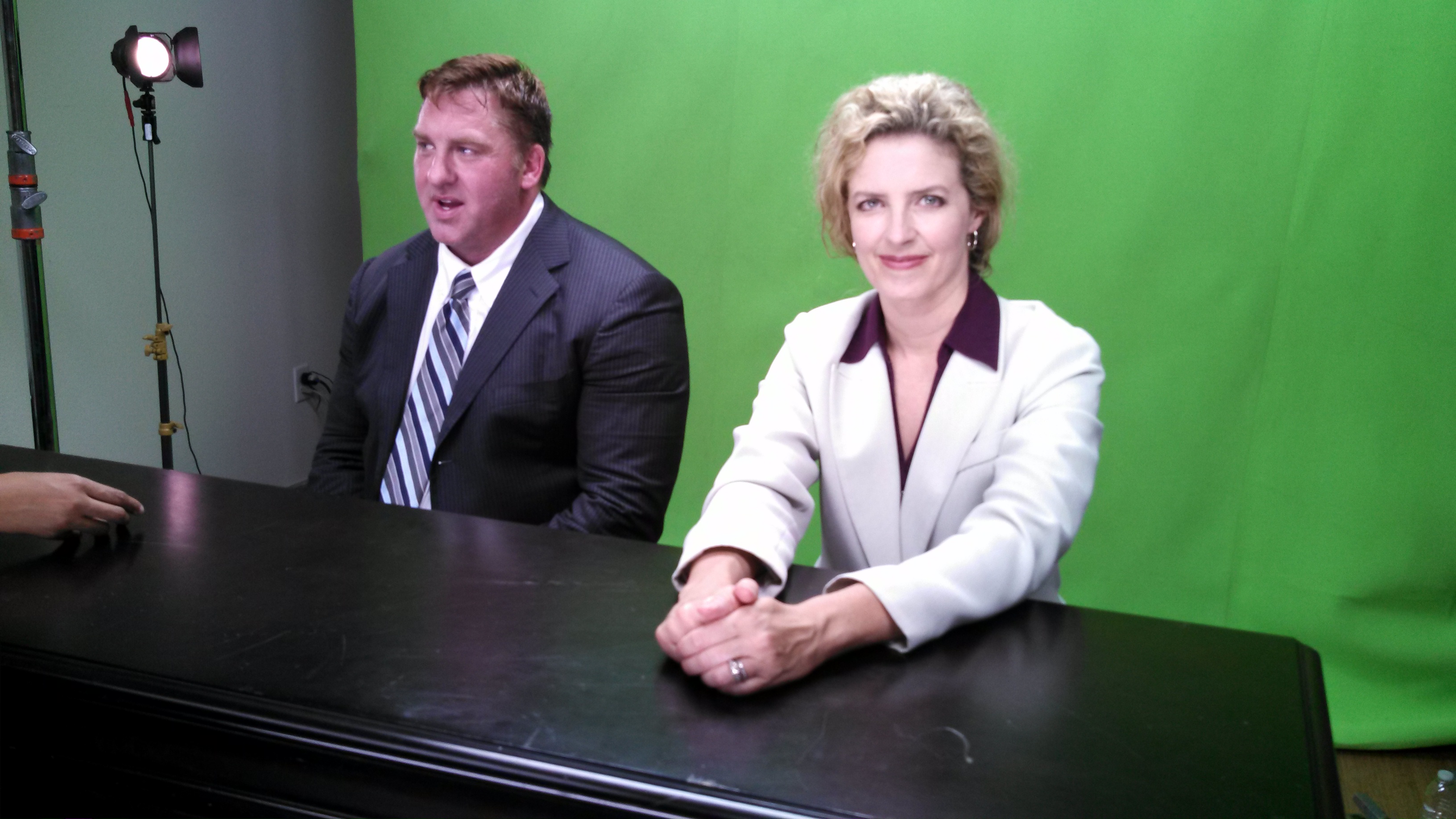 Stephanie Roede as a news anchor on the set of 