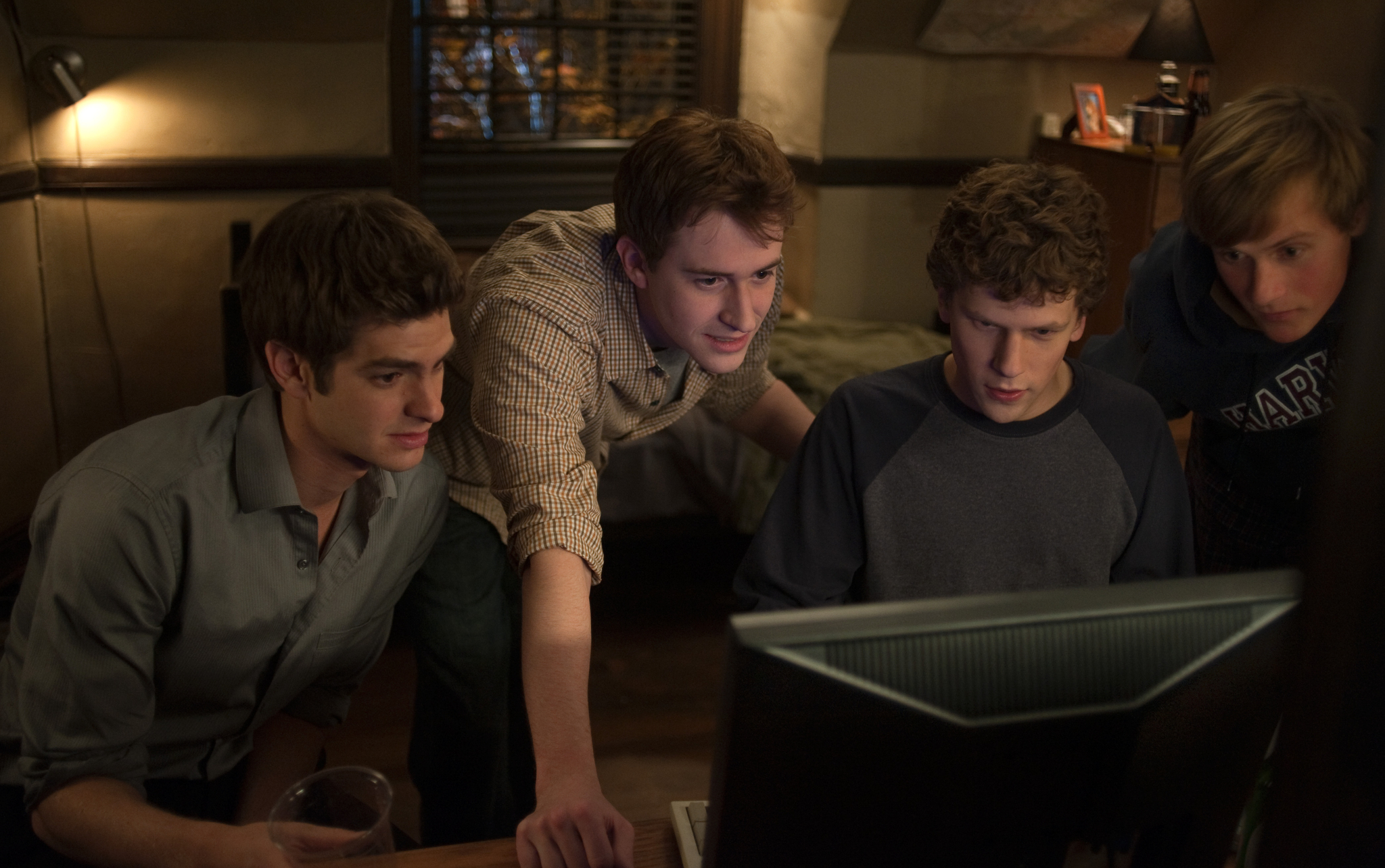 Still of Joseph Mazzello, Jesse Eisenberg, Andrew Garfield and Patrick Mapel in The Social Network (2010)