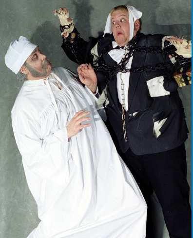 Hawke as Scrooge, cringing from Jacob Marley in Malad Civic Theater production of A Christmas Carol