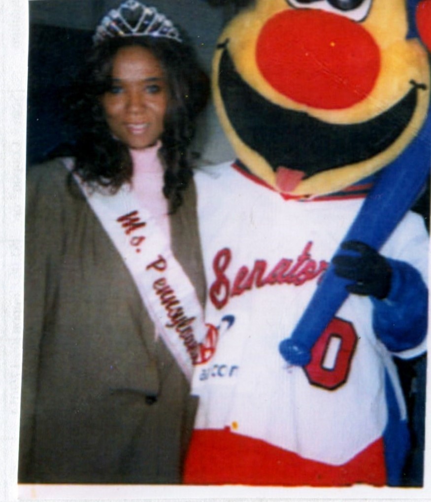 Ms.Pennsylvania 2004 Maria Frisby with the Harrisburg Senators mascot during an appearance in 2004