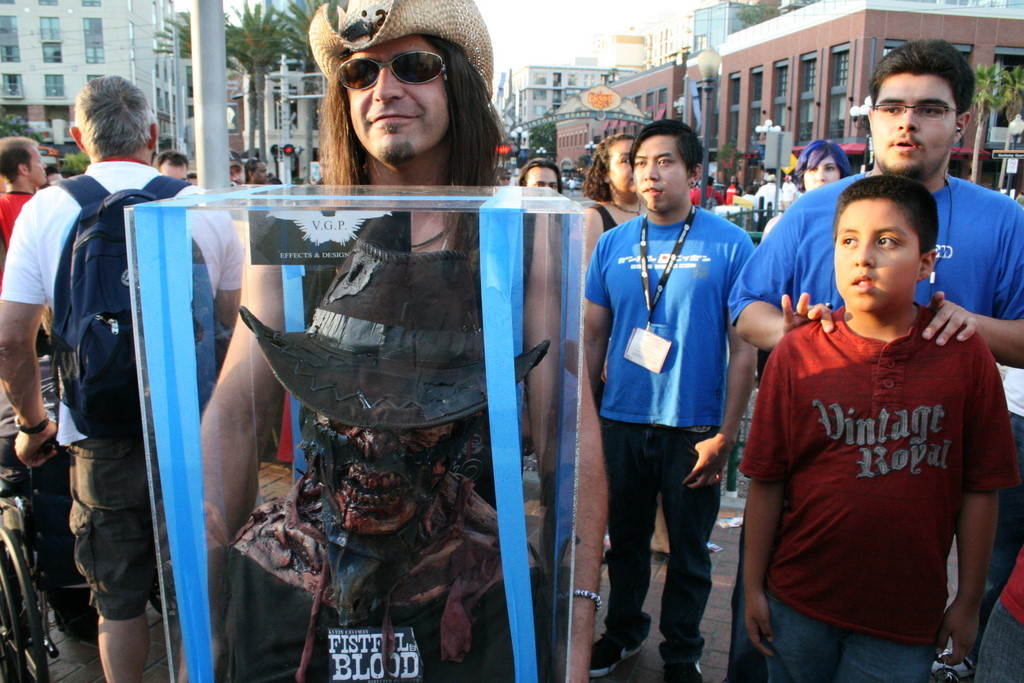 Director Digger Mesch carries a prop head for Fistful of Blood to the show floor.