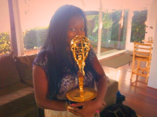 Holding an Emmy Award