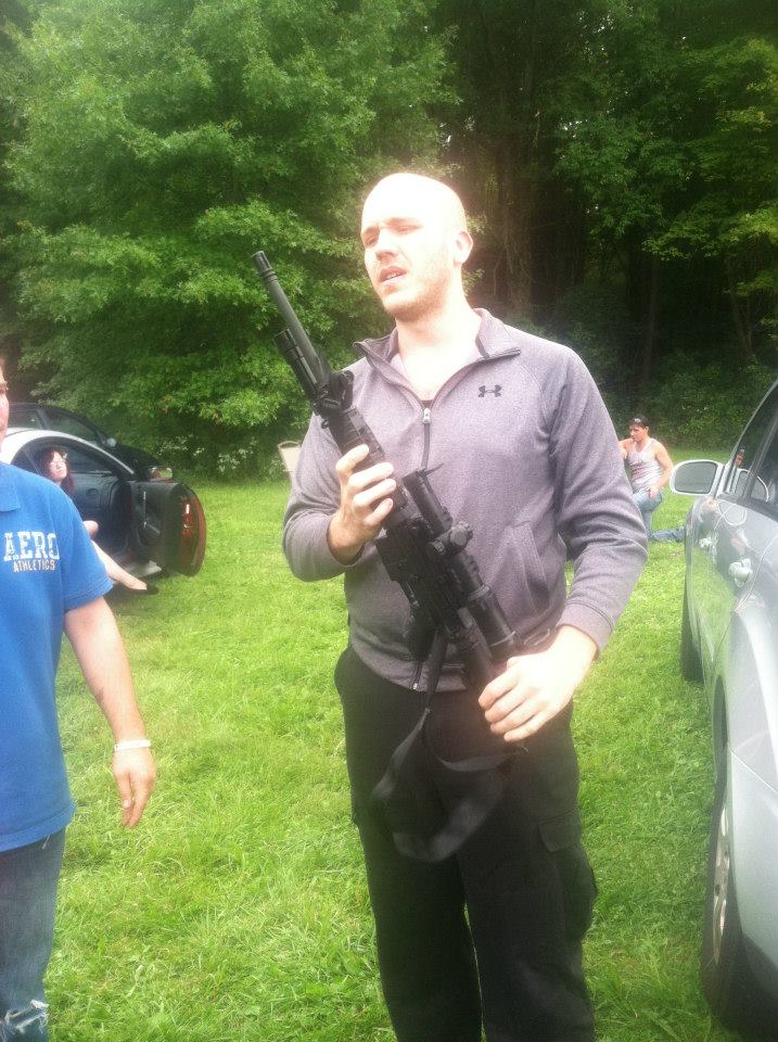 Still of Michael Hackworth Assessing an AR-15 on the set of 'The Sickness' courtesy of Preston Steele.
