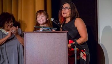 Mrs. Sorvino watches on as Taylor Richardson and Jennifer Deaton accept awards on behalf of their film Jack of the Red Hearts at the Golden Door International film festival