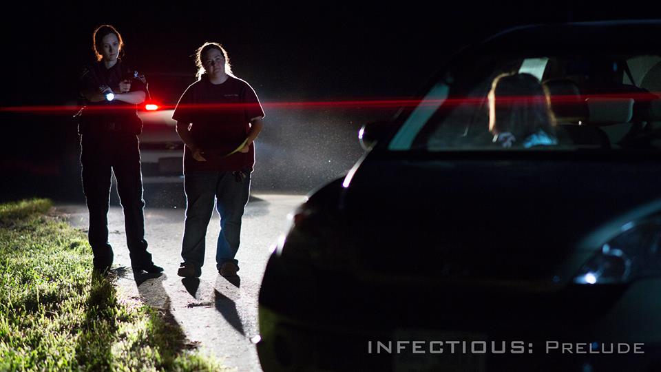 Director JL Major walks through the scene with actress Diana Porter and actress Reesa Guerra on the set of INFECTIOUS: Prelude