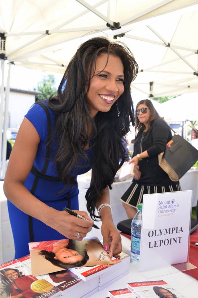 Olympia LePoint autographs books and photos for a SOLD OUT audience.