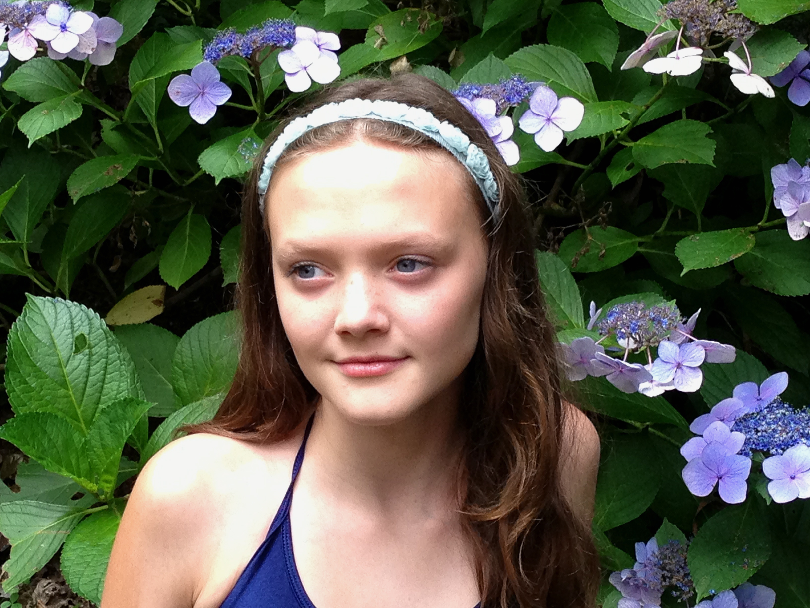 Faye in front of the flowers in her back yard.