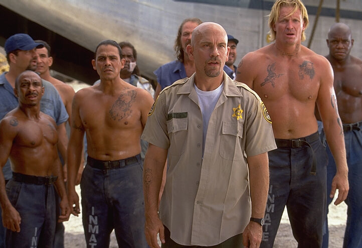 Intense scene from the Actioner CON AIR,from left to right, Ty Granderson Jones (Blade), Emilio Rivera (Carlos), John Malkovich (Cyrus the Virus)and Conrad Goode (Viking) as the gang stare down the Federal Marshals approaching from the horizon!