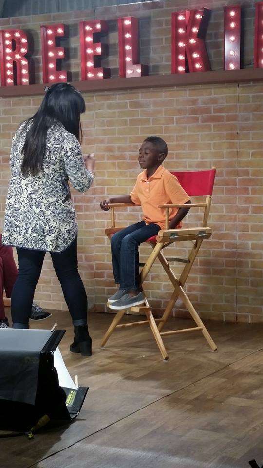 Getting my make up touch up on set of Reel Kids.