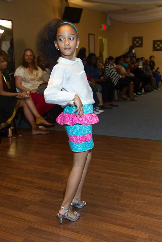 Aja at the All about Kids Fashion Show. She is wearing a custom piece by Kimanni Kouture