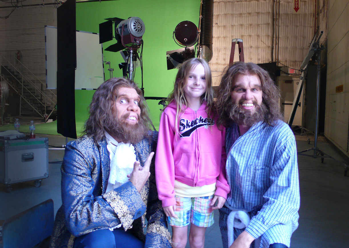 GEICO Caveman Online: Cavemen Jeff Phillips (L) , and John Lehr (R) meet with Kyra Elise Gardner prior to her going into prosthetic makeup to play the 