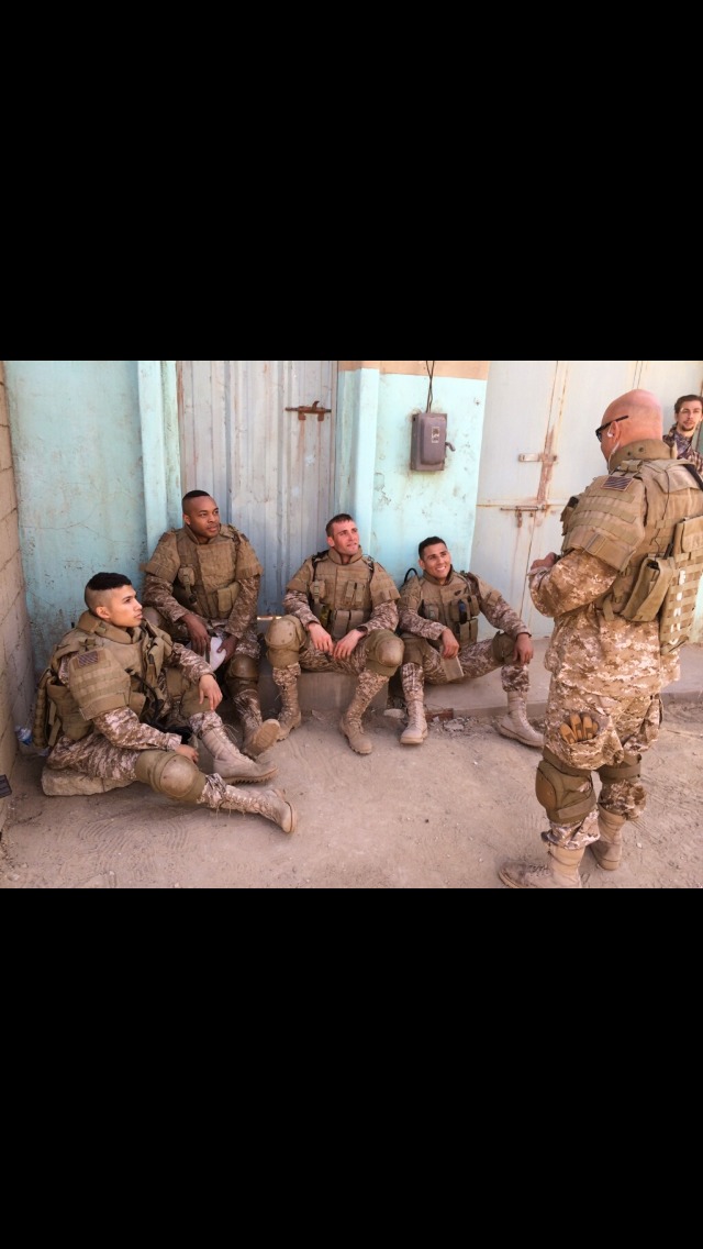 Actors Raihan Baqui, Andrew Onochie, Greg Duke, and Andres Perez-Molina listening to John J. Pistone during Devil Dogs.