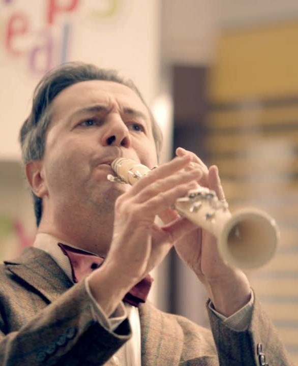 Still of Jean-Noel Martin with his white clarinet, in an advertising film (2012)