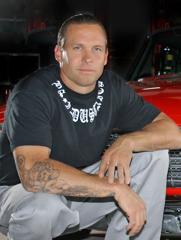 Bodie Stroud of BS Industries sits beside one of his many customized Hot Rod creations, the 2009 SEMA award-winning 1960 Ford Starliner.