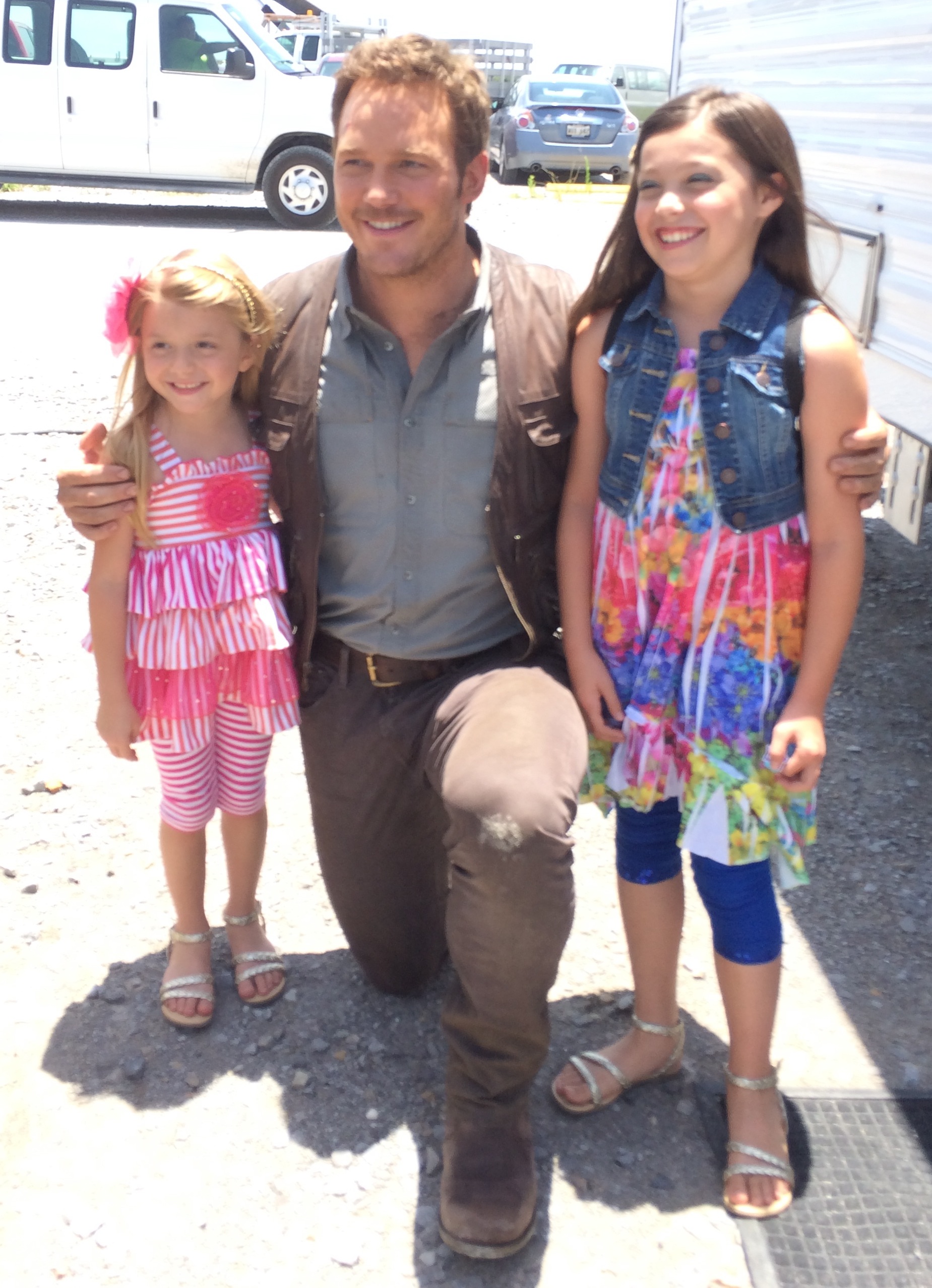 Chloe and Caitlyn Camille Perrin with Chris Pratt on the set of Jurassic World.
