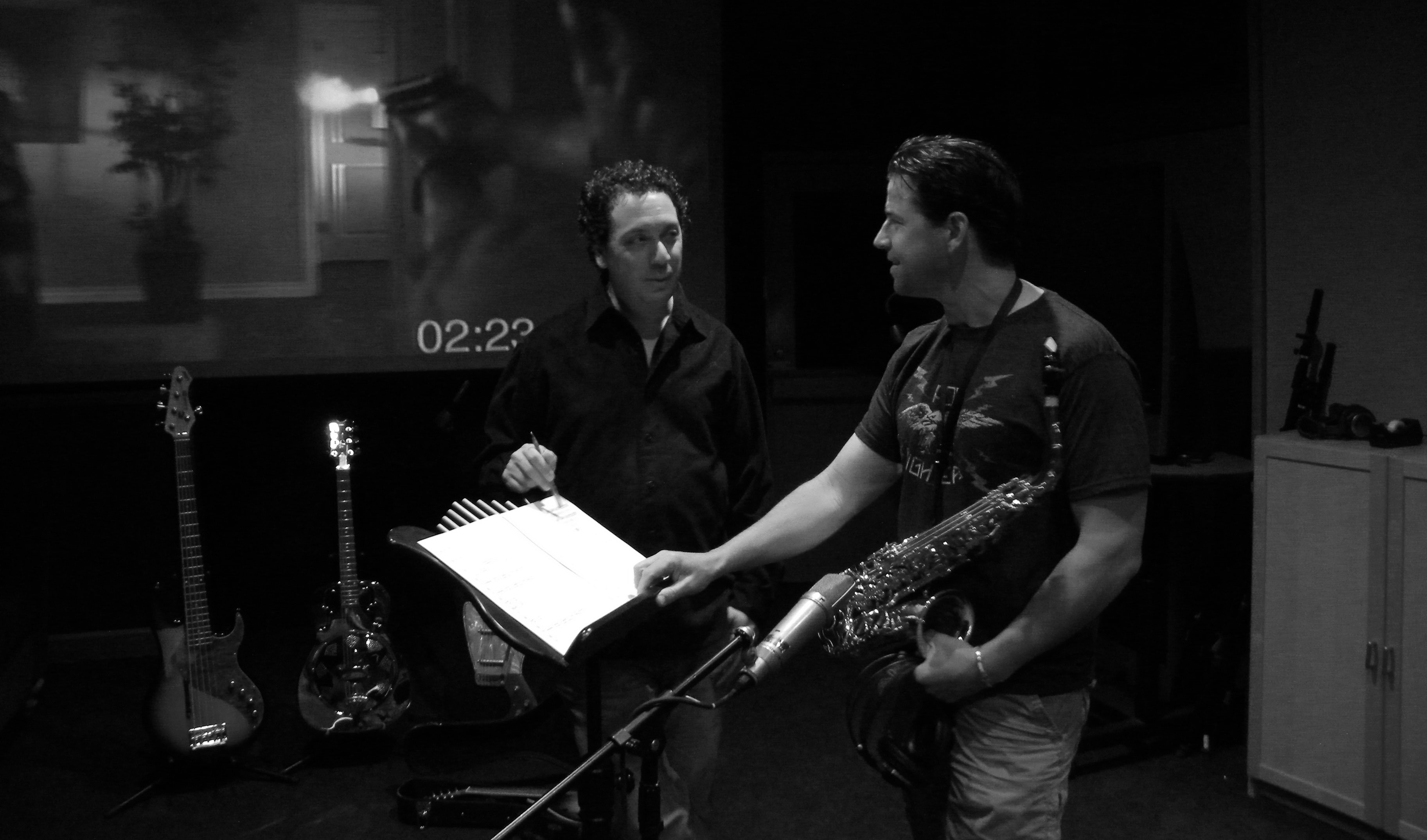 Composer Ben Zarai discussing musical performance with sax player David Barber