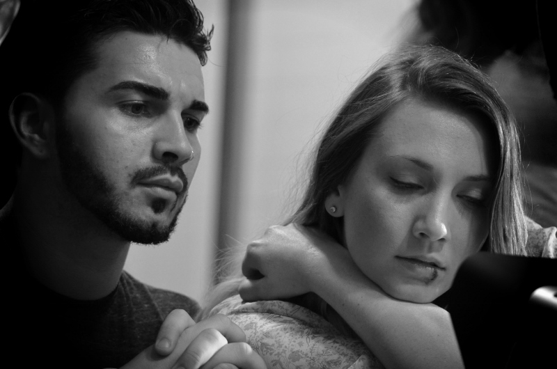 Actors Phil Araujo and Caitlyn Fletcher between takes on the set of 