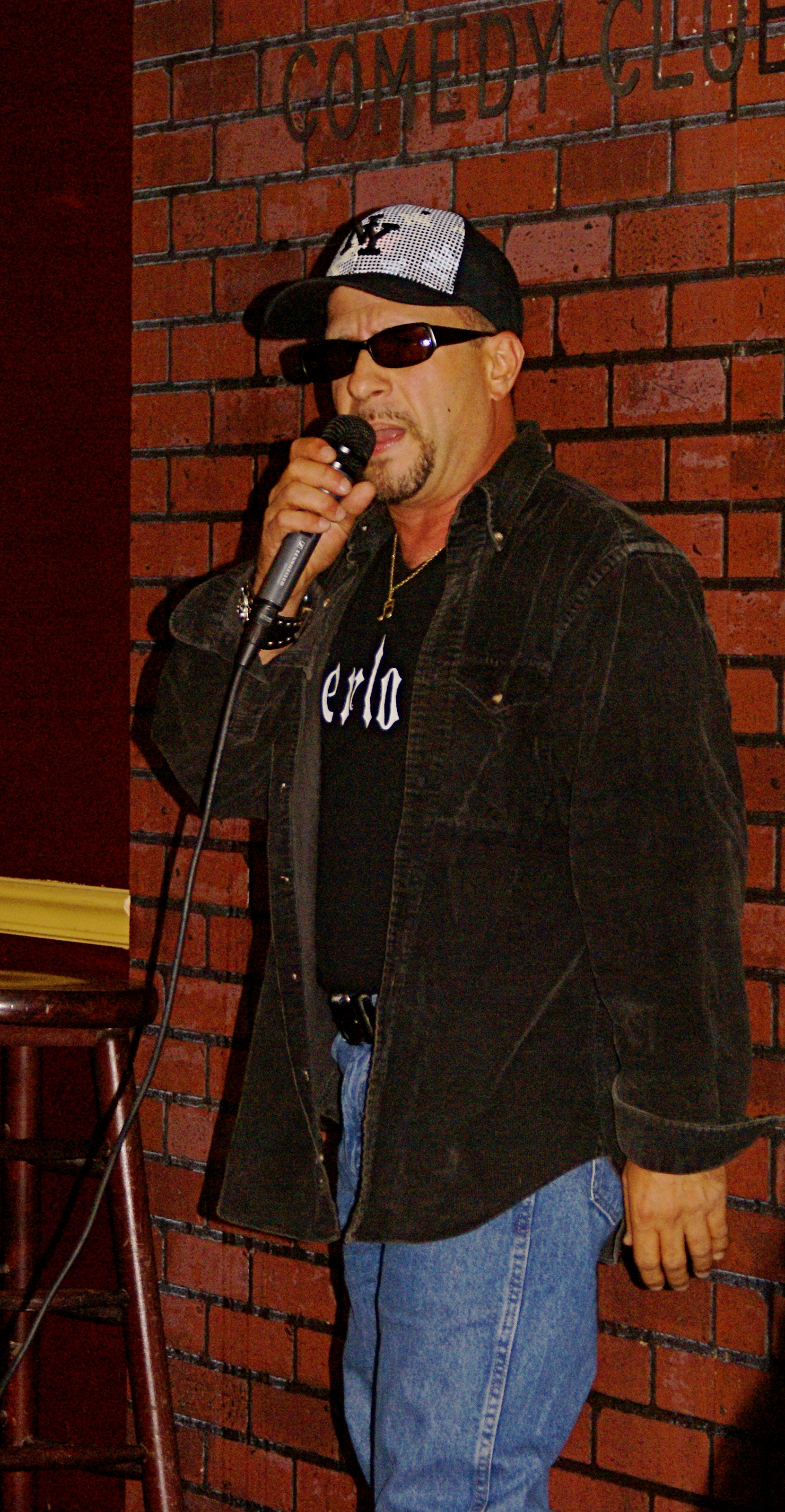Tony on stage doing standup at New York Comedy Club in the Sheba Mason Show.