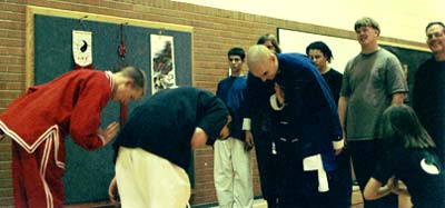 That's my bald head in 1997 receiving the Purple Patriarch Sash of Shaolin Chi Mantis. That's my daughter, 