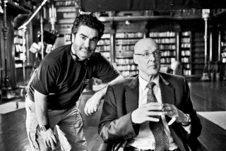 Academy Award-nominated Joe Berlinger (left) with former Secretary of the Treasury Henry Paulson (right) on the set of 