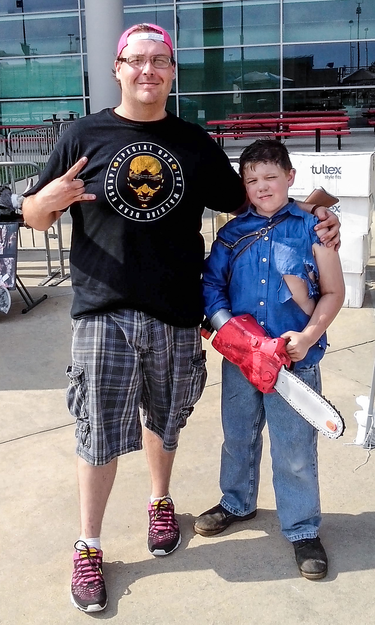A photo of myself and the son of Jason Harris, prop master, dressed as Ash from Army of Darkness outside of Reliant Stadium at The Walking Dead Escape.