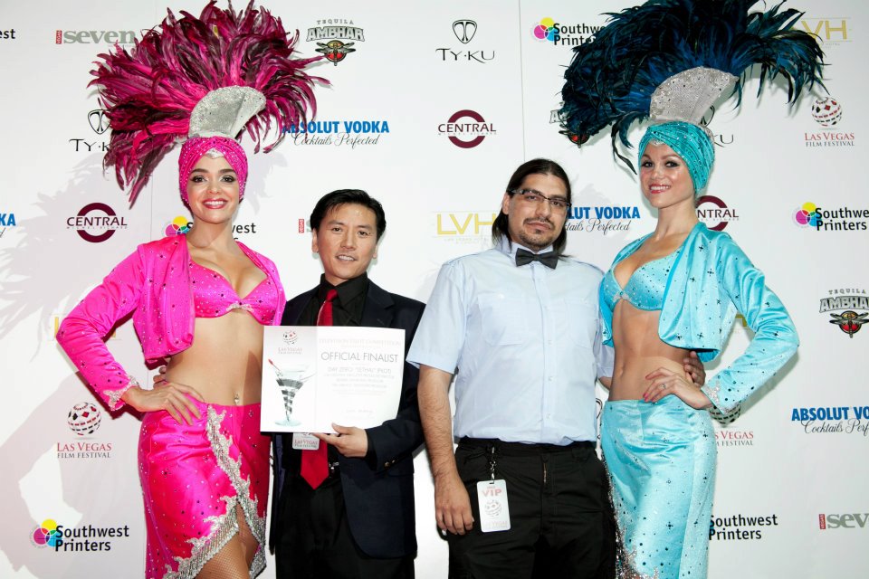 Cal Nguyen and Tim Sabuco with showgirls at the 2012 Las Vegas Film Festival, holding the Official Finalist award in the TV Pilots Competition for Day Zero the Series' pilot episode, 