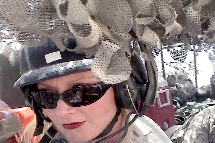 War Reporter Alex Quade in gunner's turret, during mounted armored vehicle patrols of Baqubah, Iraq. 2007.