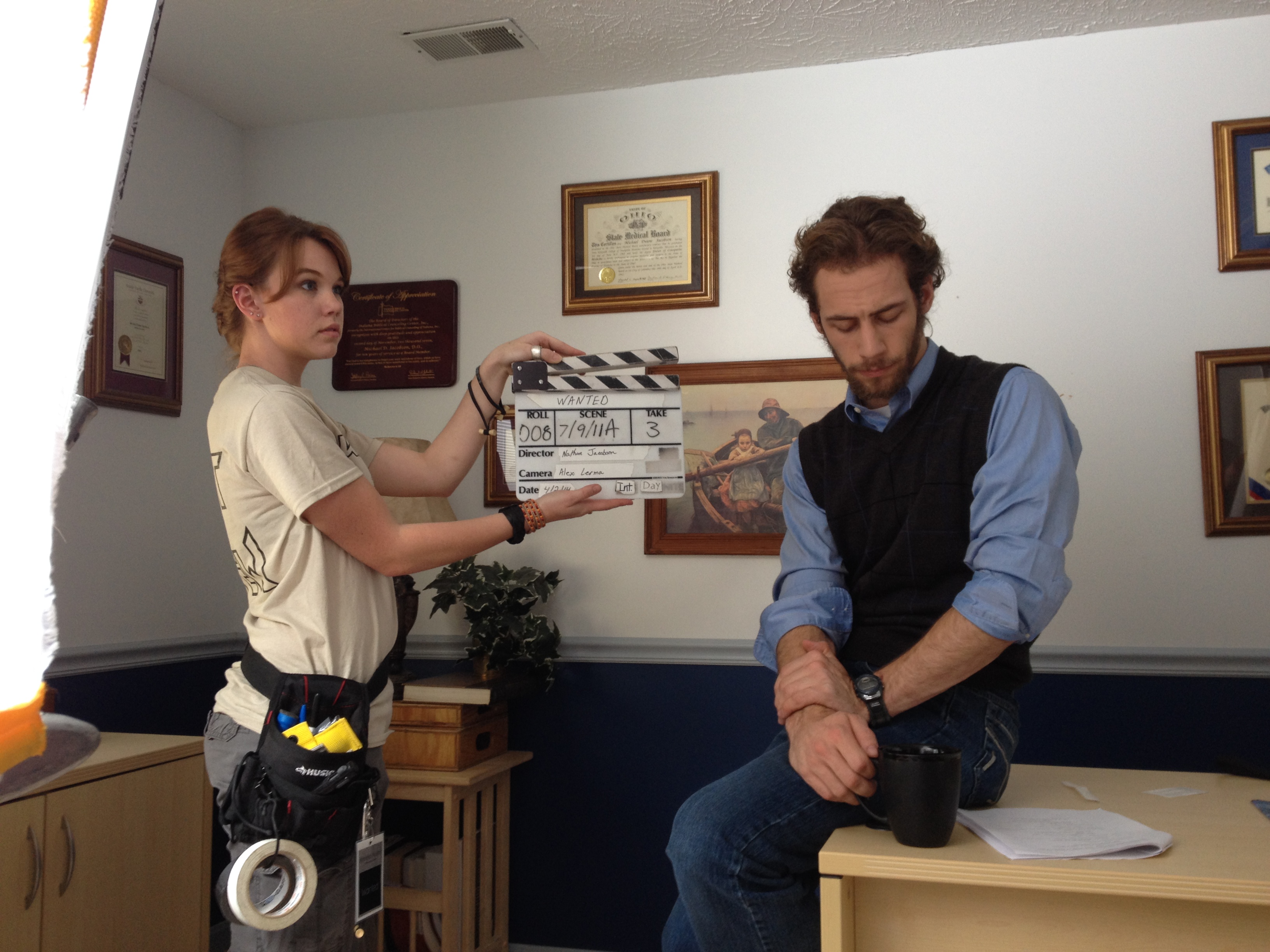 Production still of 2nd AC Amelia Austin with Nathan Jacobson on the set of Wanted (2014).