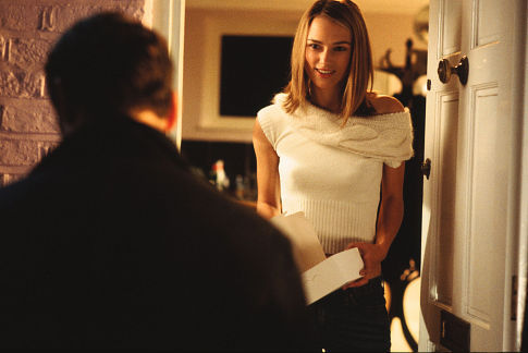 Juliet (KEIRA KNIGHTLEY) opens the door to a hopeful crush (ANDREW LINCOLN as Mark) in Richard Curtis' ensemble romantic comedy Love Actually.