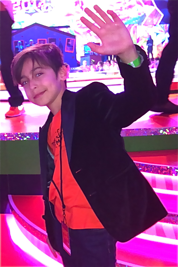 Aidan Gallagher at the 2014 Nickelodeon Kids Choice Awards. Hair by Stephanie Lewis, custom velvet tuxedo jacket by John Varvatos, environmental tshirt by Kitson Malibu, skinny jeans by Joes Jeans.