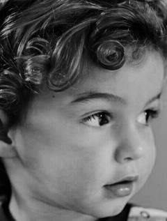 Zac england age 21 months, has curly hair and is not shy to have his photo taken,