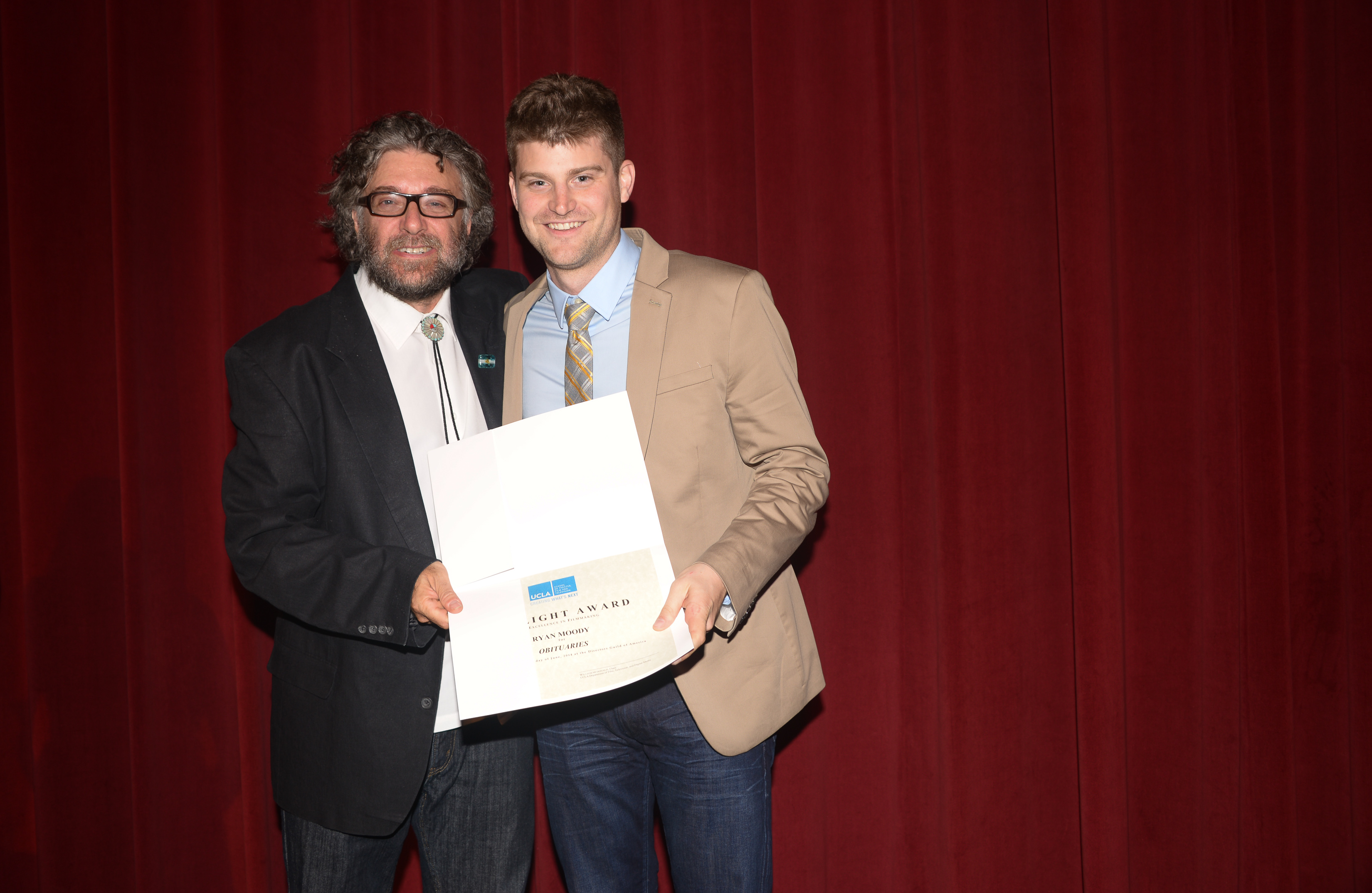 Vice Chair of the UCLA Dept. of Film, Television & Digital Media presenting Ryan Moody with the Spotlight Award for Obituaries.