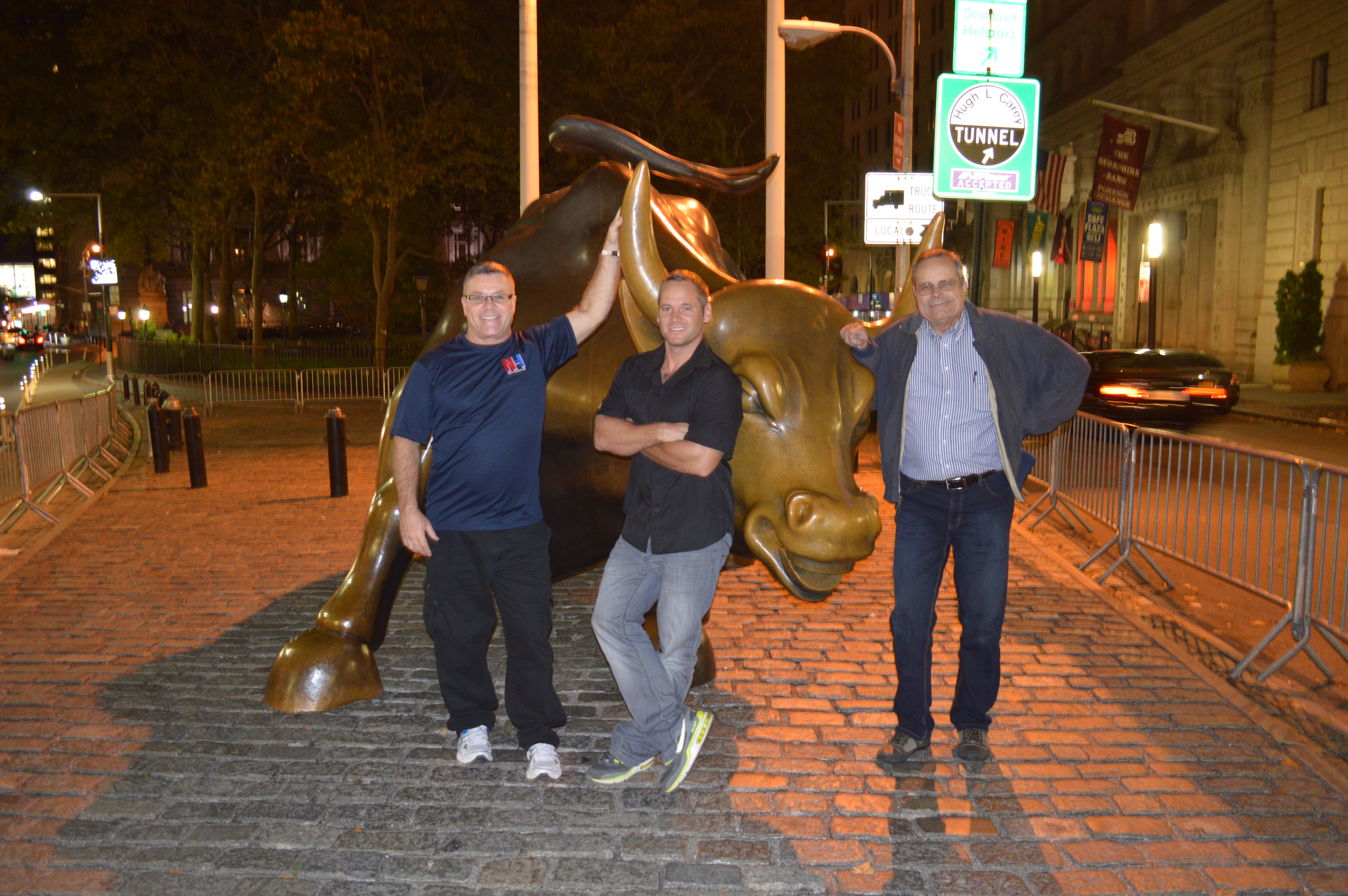 NYSE Bull near Wall St. NYC Robert Nash, Nick Peters and David Stewart