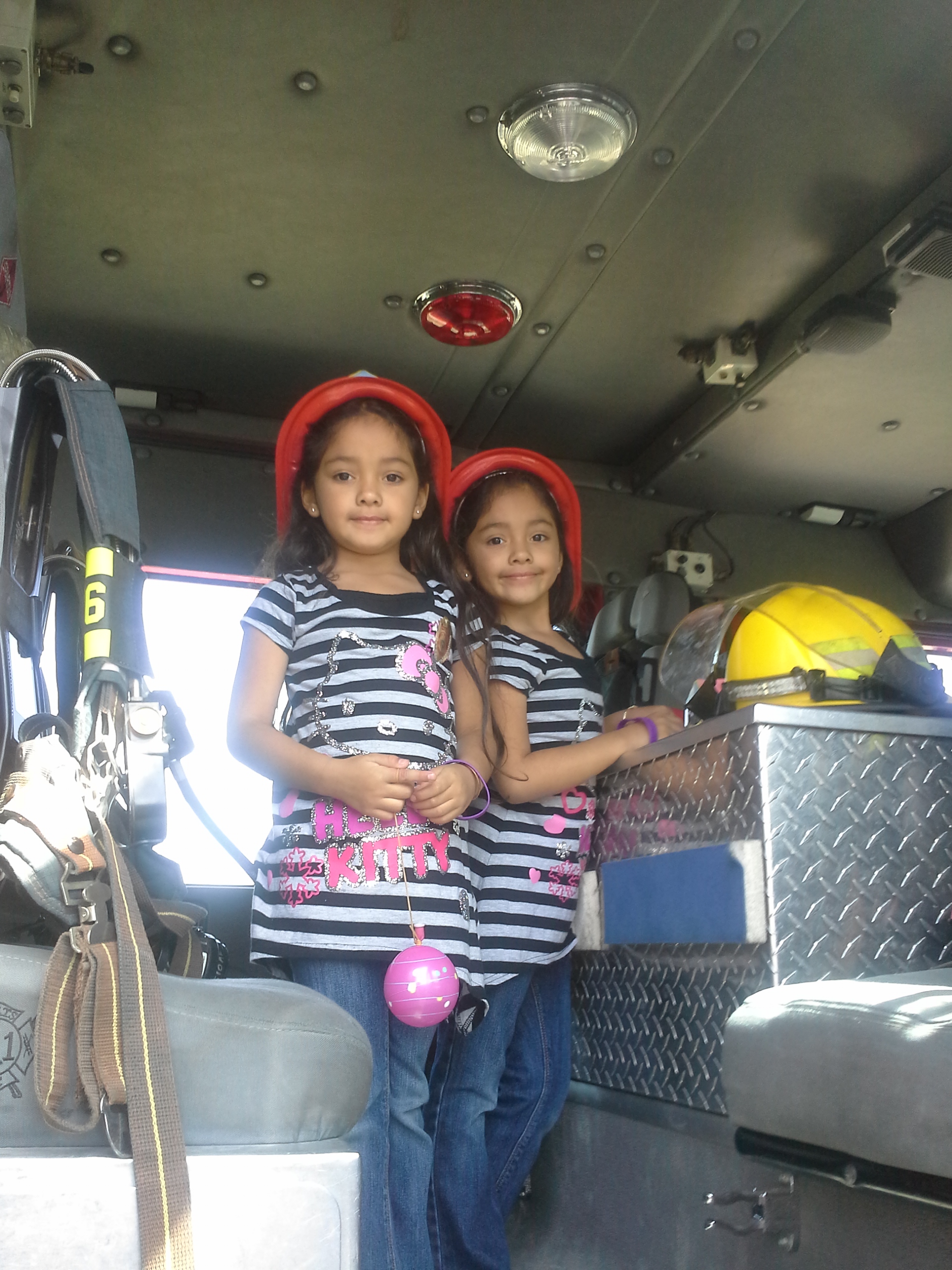 Nalena & Lavena hanging out in the fire truck during Vietnamese New Year 2014.