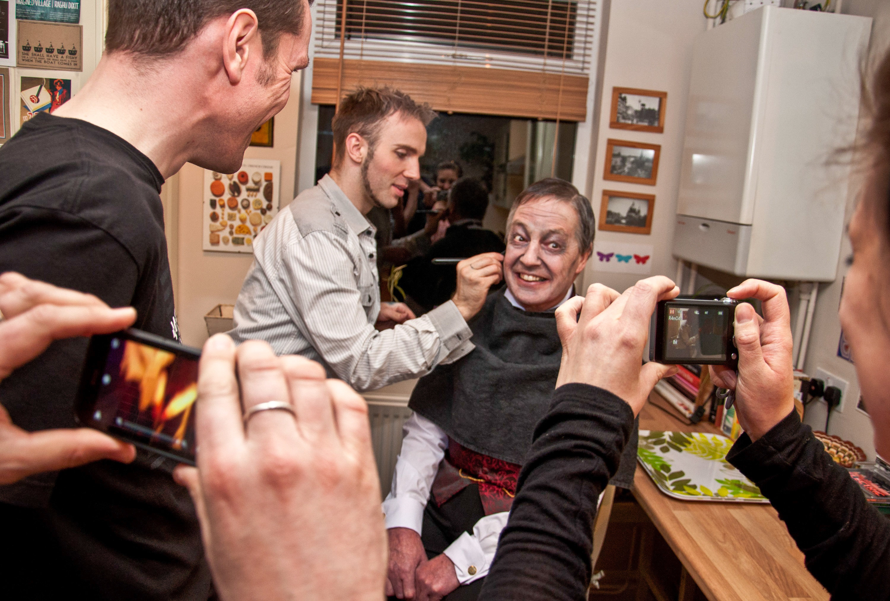 Adam-Thomas Bane applies Ian Clegg's make-up as The Brethren (2013) director Shane Wheeler and crew look on.