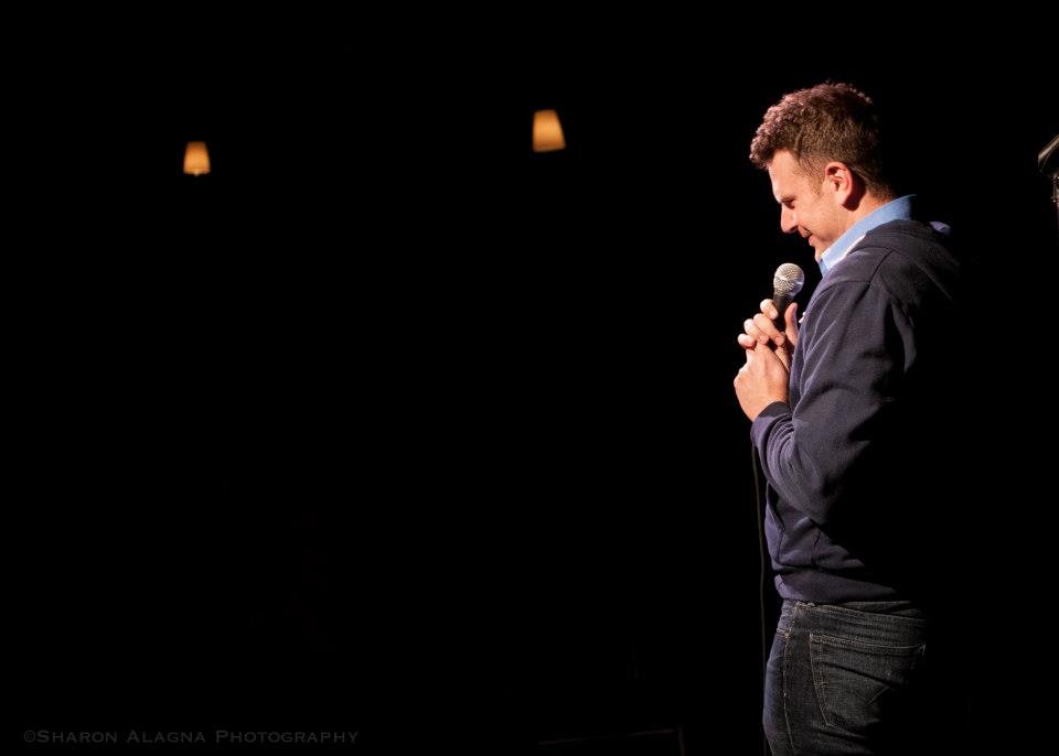 Anthony DeVries doing stand up in the darkest room on earth.