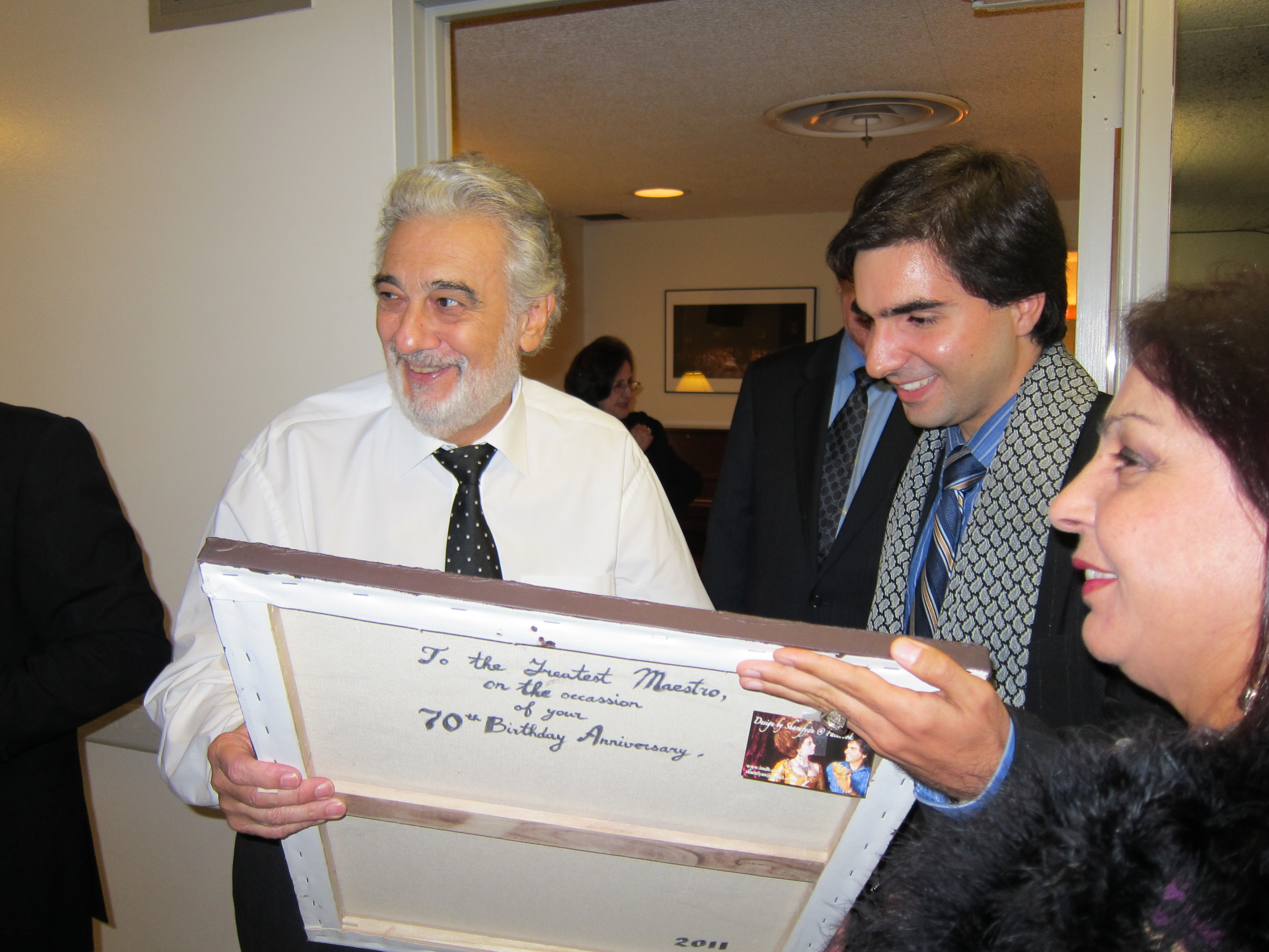 Mikael is presenting to Maestro Placido Domingo his portrait that he painted. November 6, 2011