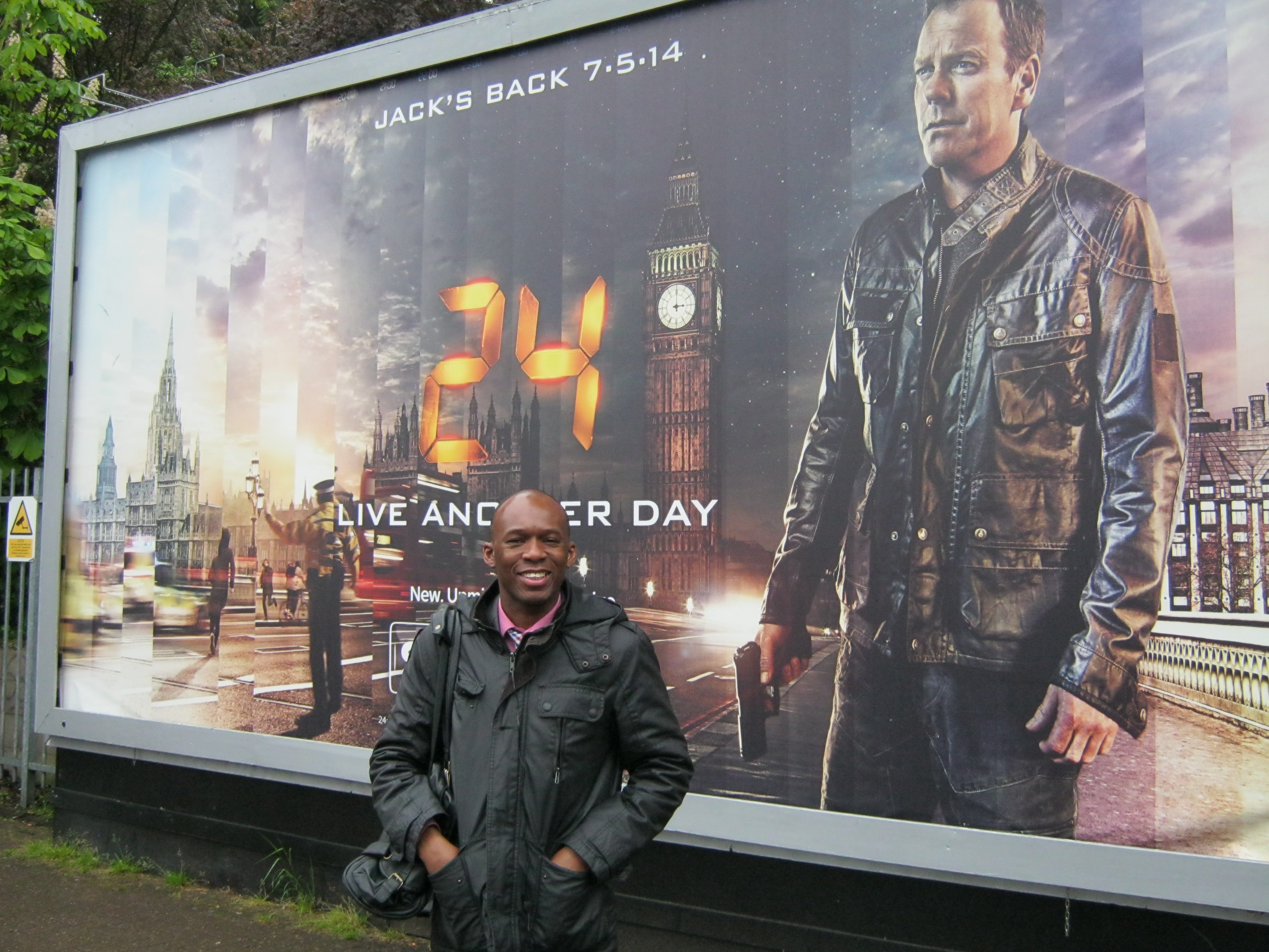 David Olawale Ayinde, Actor, Standing near a Promotion Poster for the show which currently filmed in London, UK.