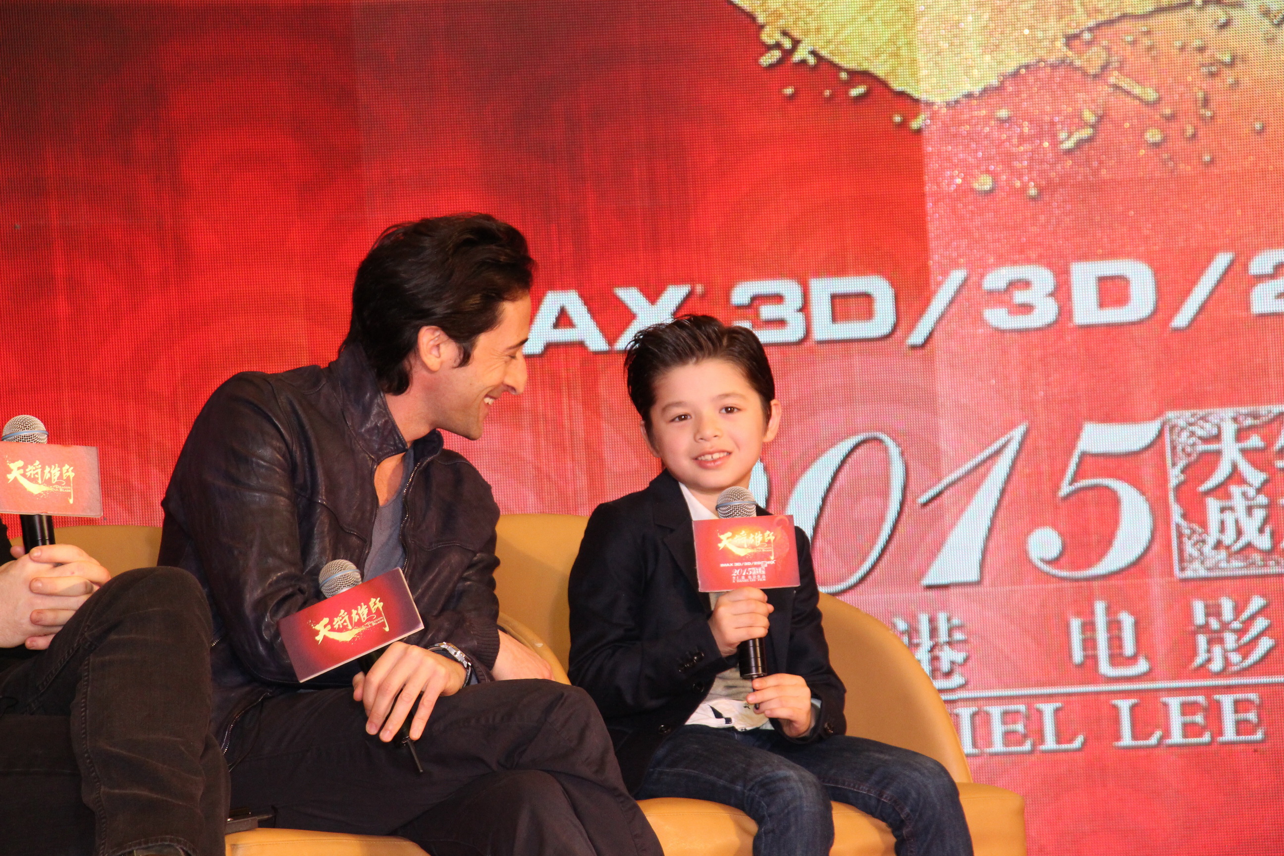 Adrien Brody is amused with Jozef Waite's story in Beijing, China at the Dragon Blade premiere. February 2015.