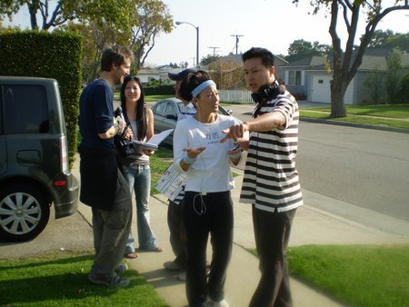 Tom Huang and Tamlyn Tomita setting up for the next shot on the set of 