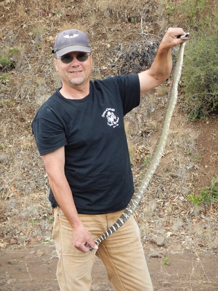 Capt. Bill with a formerly grumpy rattlesnake... now dispatched.