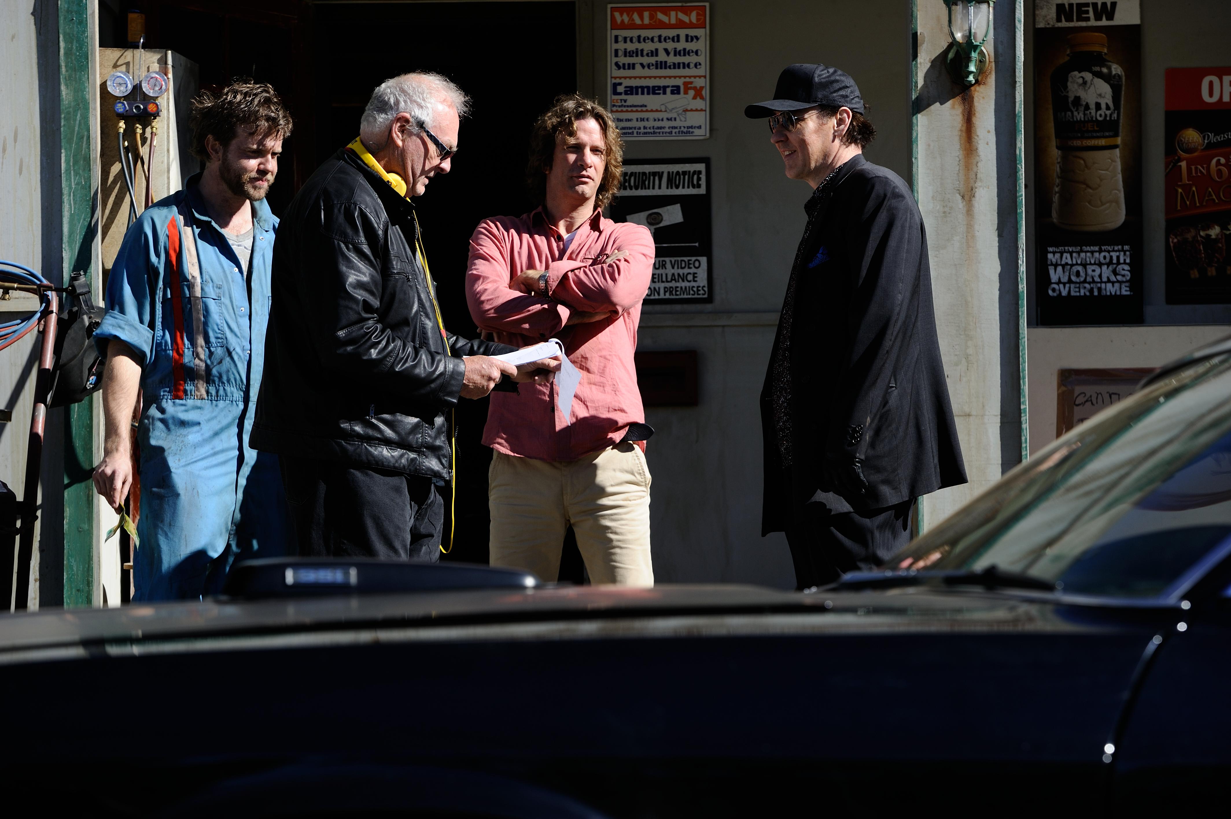 FROM L TO R: Christopher Sommers, Brian Trenchard Smith, Thomas Jane and John Cusack talk through a scene from Drive Hard