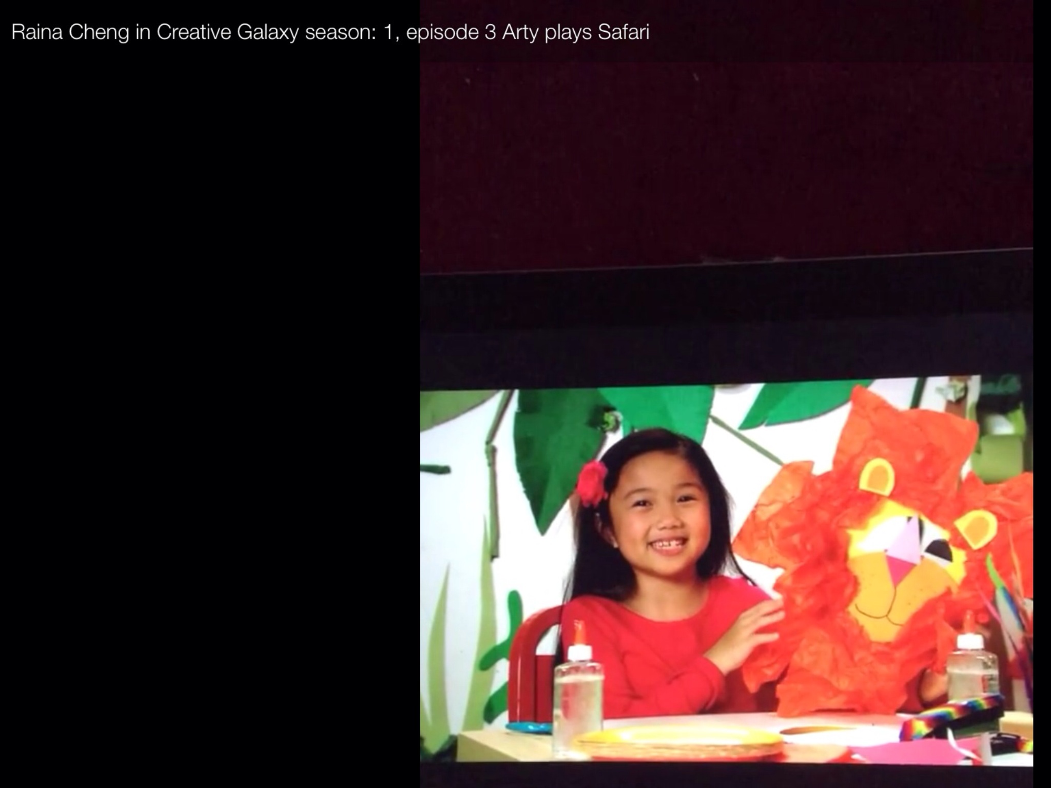 Raina Cheng demonstrates to viewers how to make a lion mask craft on the Web Series, CREATIVE GALAXY. 2014