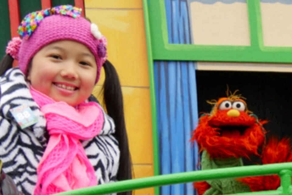 Raina Cheng on the Sesame Street Float at the 88th Macy's Thanksgiving Day Parade 2014